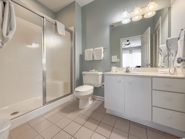 full bathroom featuring toilet, vanity, a stall shower, tile patterned flooring, and baseboards