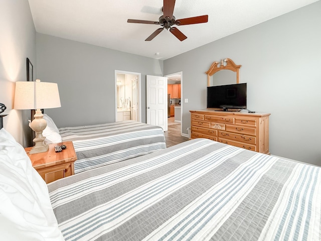 bedroom featuring ceiling fan, ensuite bathroom, and wood finished floors