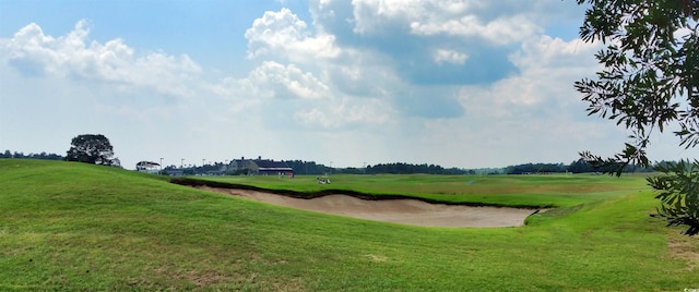 view of community featuring golf course view and a lawn