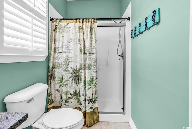 bathroom featuring a shower stall and toilet