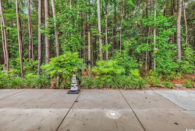 view of patio featuring a forest view