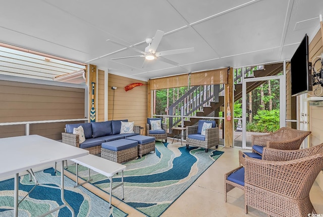 sunroom / solarium featuring ceiling fan and outdoor lounge area