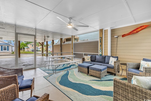 sunroom with a ceiling fan, healthy amount of natural light, and outdoor lounge area
