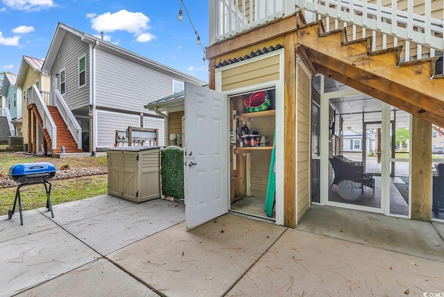 view of outbuilding featuring stairs and central air condition unit