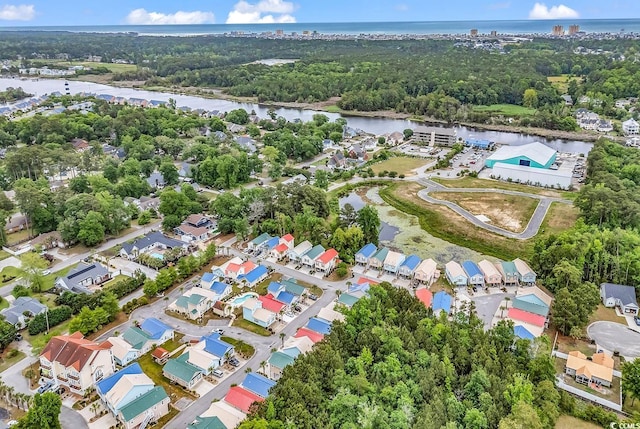 aerial overview of property's location featuring a nearby body of water and nearby suburban area