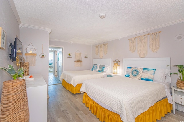 200 76th Ave N Unit 408, Myrtle Beach, SC 29572 - bedroom featuring light wood finished floors, crown molding, and a textured ceiling