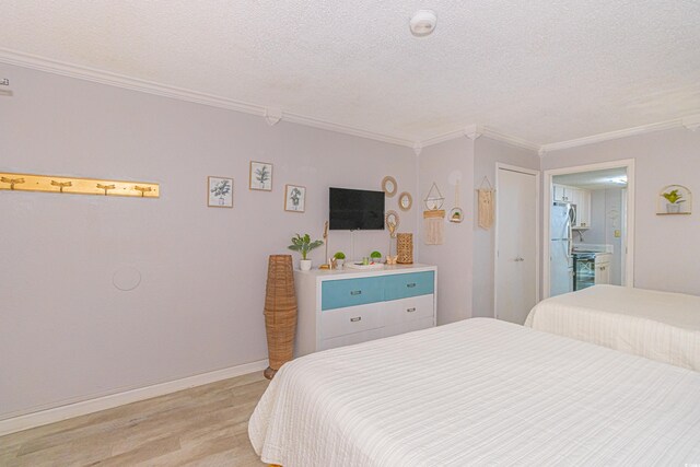 200 76th Ave N Unit 408, Myrtle Beach, SC 29572 - bedroom with freestanding refrigerator, a textured ceiling, crown molding, and light wood-type flooring