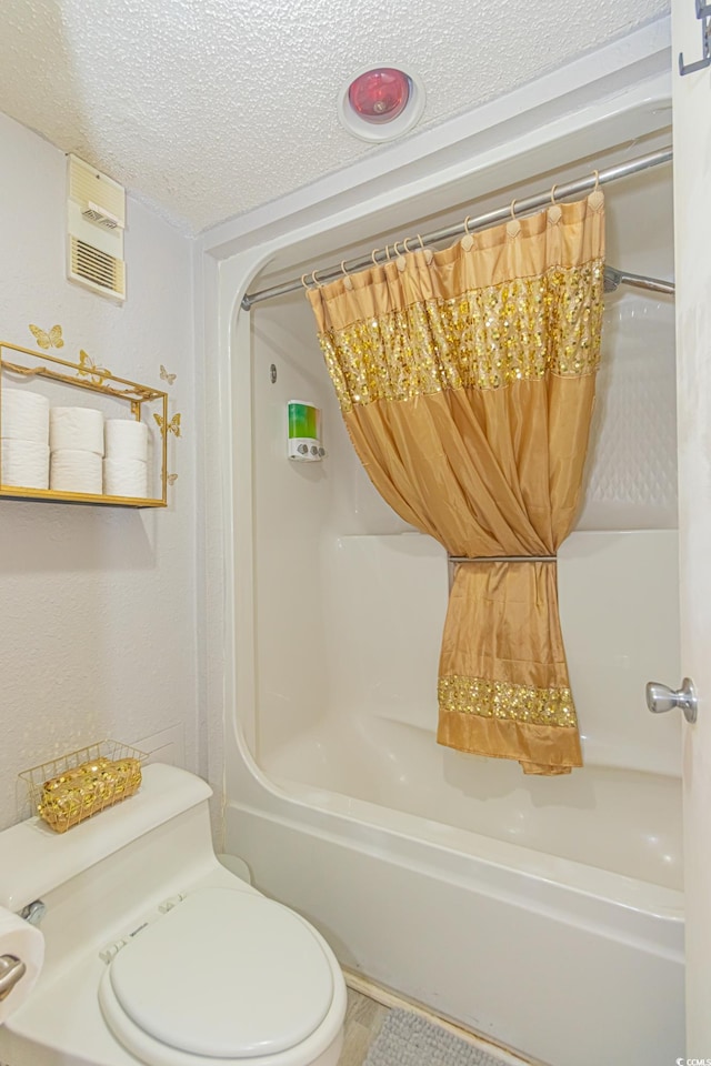 200 76th Ave N Unit 408, Myrtle Beach, SC 29572 - full bathroom with a textured ceiling, visible vents, toilet, and shower / bathtub combination with curtain