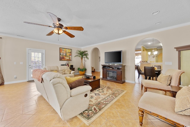 living area featuring light tile patterned floors, arched walkways, crown molding, a textured ceiling, and a ceiling fan