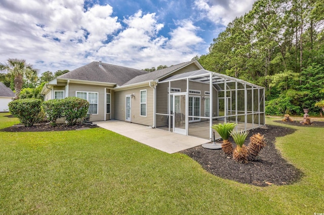 rear view of property featuring a patio area, a lawn, and roof with shingles