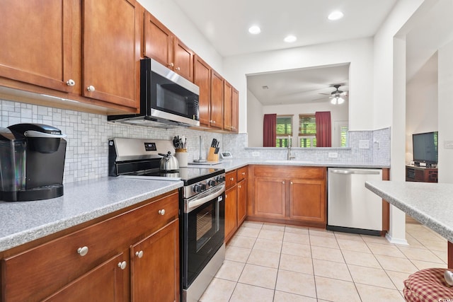 157 Olde Towne Way Unit 4, Myrtle Beach, SC 29588 - kitchen featuring a sink, ceiling fan, stainless steel appliances, and brown cabinets
