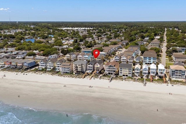 drone / aerial view with a water view, a residential view, and a beach view