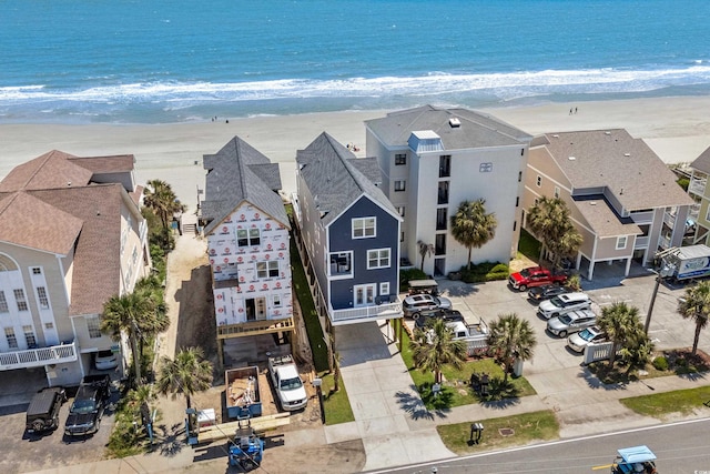 birds eye view of property with a water view and a view of the beach