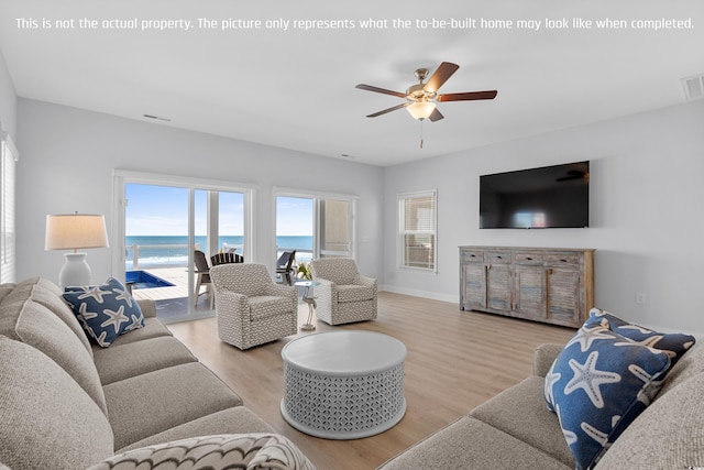 living room with a ceiling fan, baseboards, visible vents, and wood finished floors