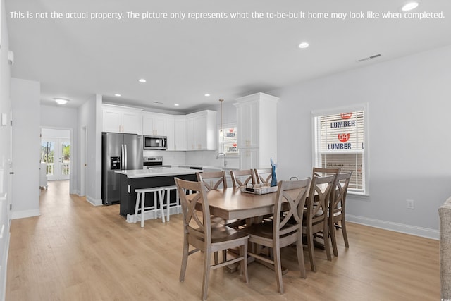 dining room with baseboards, recessed lighting, light wood finished floors, and visible vents