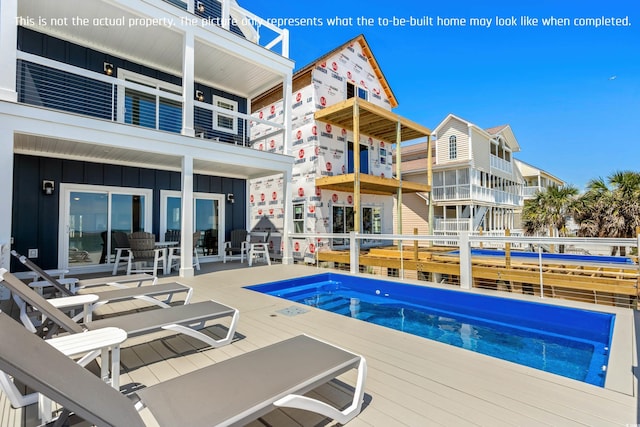 view of pool with a hot tub