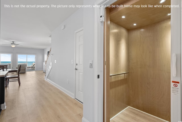 hall with stairway, baseboards, elevator, light wood-style floors, and recessed lighting
