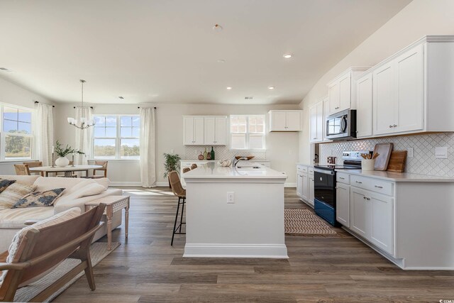 725 Choctaw Dr, Conway, SC 29526 - kitchen featuring electric range oven, stainless steel microwave, a sink, a chandelier, and dark wood-type flooring