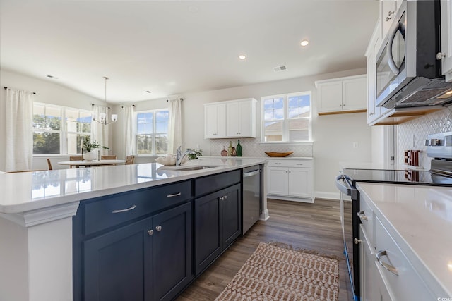 725 Choctaw Dr, Conway, SC 29526 - kitchen with appliances with stainless steel finishes, white cabinetry, an island with sink, light countertops, and decorative backsplash