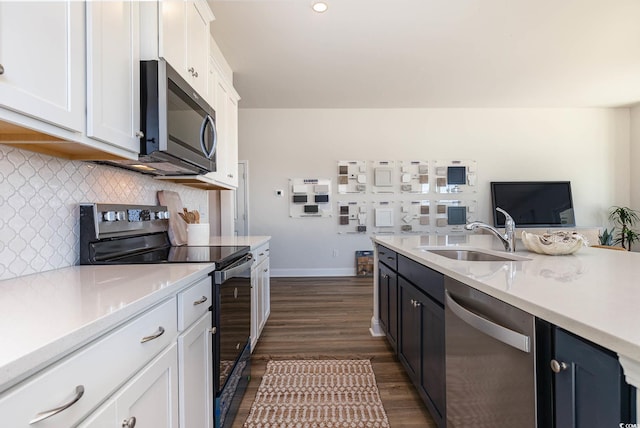 725 Choctaw Dr, Conway, SC 29526 - kitchen featuring stainless steel appliances, a sink, dark wood finished floors, light countertops, and white cabinetry