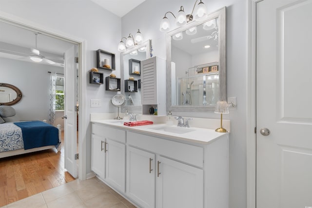 bathroom featuring a sink, ensuite bathroom, an enclosed shower, and tile patterned floors