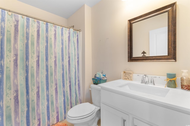 bathroom with toilet, vanity, and a shower with curtain