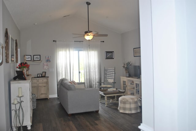 living room with dark wood-style flooring, ceiling fan, vaulted ceiling, and baseboards