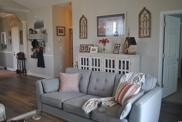 living room with arched walkways, wood finished floors, baseboards, and ornate columns