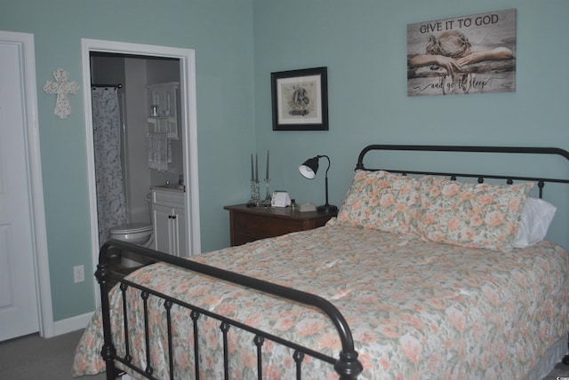 carpeted bedroom with baseboards and connected bathroom