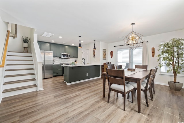 dining area featuring stairs, a notable chandelier, visible vents, light wood-style floors, and recessed lighting