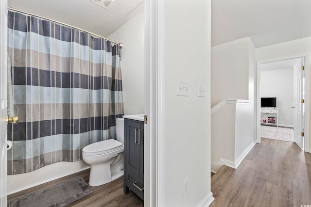 full bathroom with toilet, wood finished floors, vanity, visible vents, and a shower with shower curtain