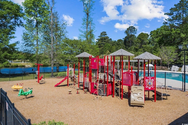 community jungle gym featuring a community pool and fence