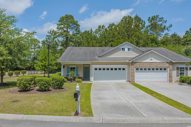view of front facade with concrete driveway, brick siding, an attached garage, and a front lawn