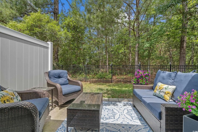 view of patio / terrace featuring an outdoor living space and fence
