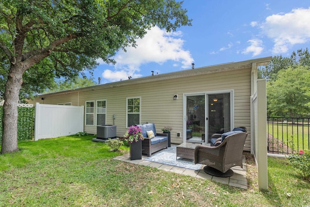 back of property featuring an outdoor living space, central air condition unit, and a patio