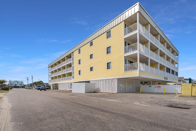 view of building exterior featuring uncovered parking