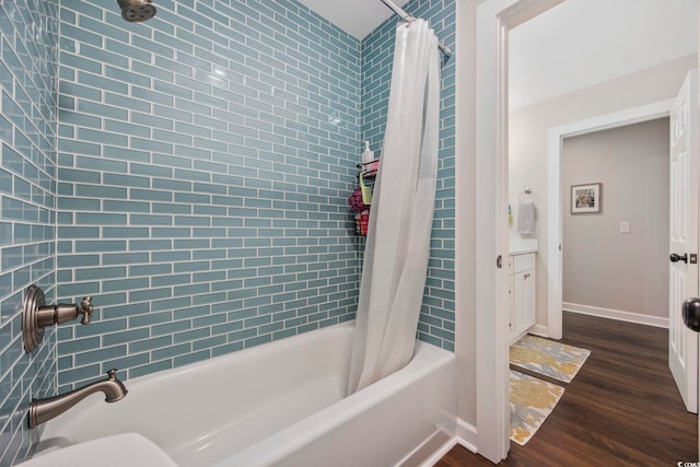full bathroom with baseboards, shower / bath combination with curtain, and wood finished floors