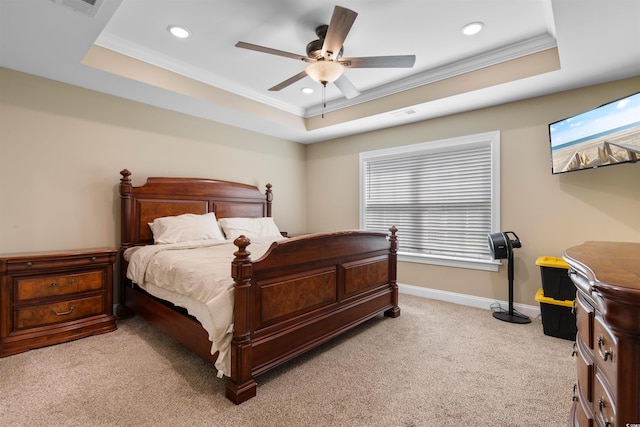 bedroom featuring a tray ceiling, recessed lighting, baseboards, ornamental molding, and light colored carpet