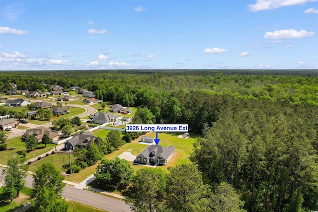 birds eye view of property featuring a residential view and a view of trees