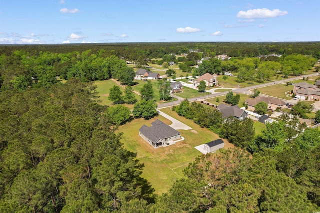 aerial view featuring a view of trees and a residential view