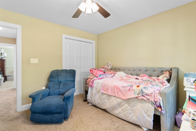 bedroom featuring a ceiling fan, baseboards, a closet, and carpet floors
