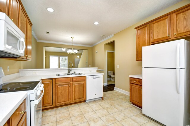 6172 Catalina Dr Unit 214, North Myrtle Beach, SC 29582 - kitchen featuring white appliances, a sink, brown cabinets, ornamental molding, and recessed lighting