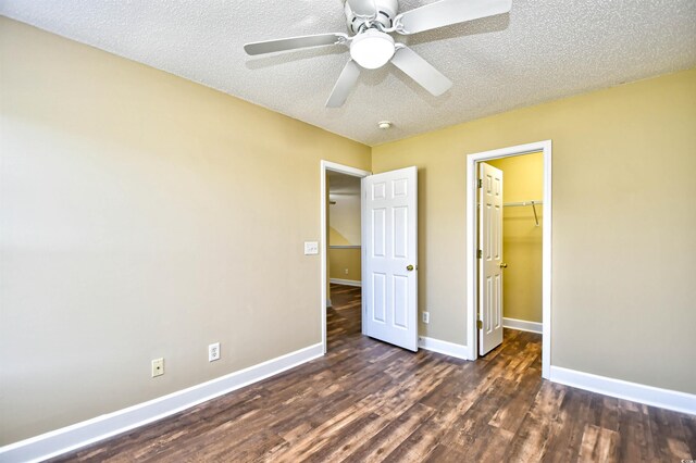 6172 Catalina Dr Unit 214, North Myrtle Beach, SC 29582 - unfurnished bedroom featuring wood finished floors, baseboards, a textured ceiling, a walk in closet, and a closet