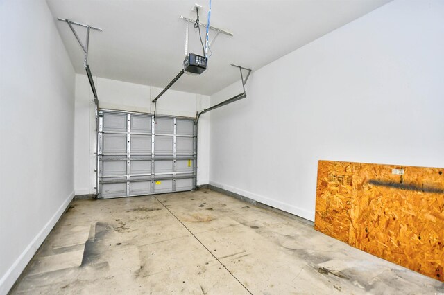 6172 Catalina Dr Unit 214, North Myrtle Beach, SC 29582 - garage with a garage door opener and baseboards