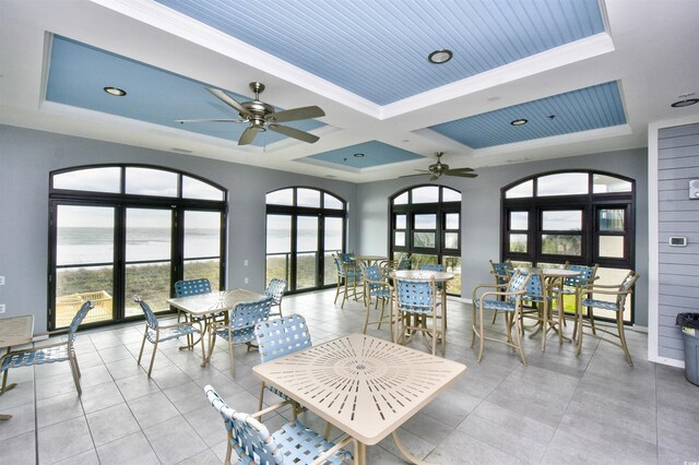 6172 Catalina Dr Unit 214, North Myrtle Beach, SC 29582 - dining space with a ceiling fan, a raised ceiling, a water view, coffered ceiling, and crown molding