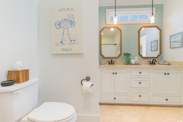 bathroom with toilet, tile patterned floors, and double vanity