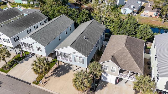 aerial view of residential area featuring a nearby body of water