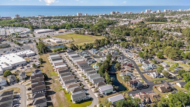 aerial view of property and surrounding area with a nearby body of water, nearby urban area, and nearby suburban area