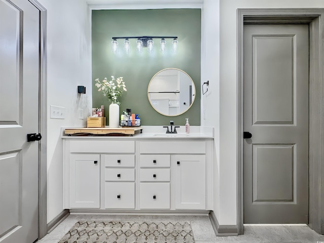 bedroom featuring a tray ceiling, light wood-style flooring, and baseboards