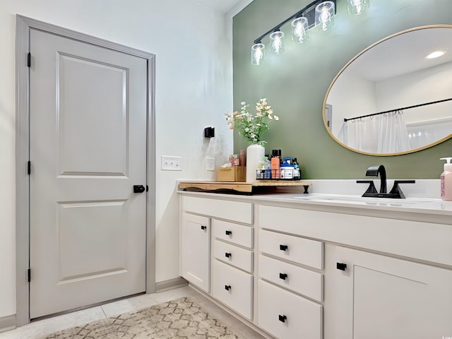 bathroom with vanity and baseboards